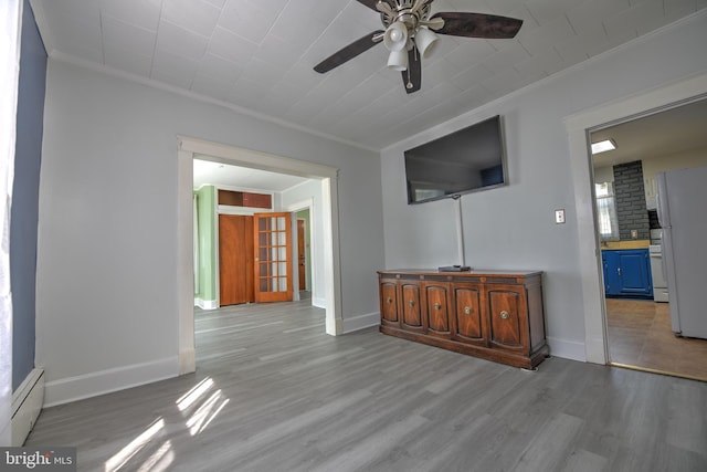 5417 Wasena Ave, Baltimore, MD 21225 - living area with ornamental molding, a ceiling fan, a baseboard heating unit, and wood finished floors