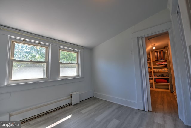 5417 Wasena Ave, Baltimore, MD 21225 - empty room featuring baseboard heating, lofted ceiling, and wood finished floors