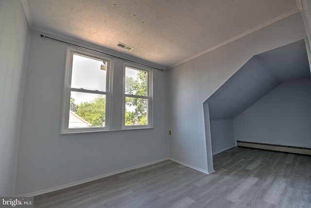5417 Wasena Ave, Baltimore, MD 21225 - additional living space featuring a baseboard heating unit and wood finished floors