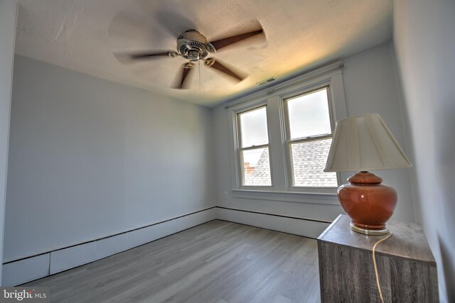 5417 Wasena Ave, Baltimore, MD 21225 - unfurnished room with light wood-style flooring, a ceiling fan, and a textured ceiling