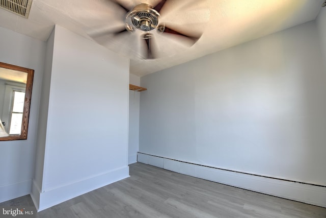 5417 Wasena Ave, Baltimore, MD 21225 - unfurnished room with ceiling fan, a baseboard radiator, and wood finished floors