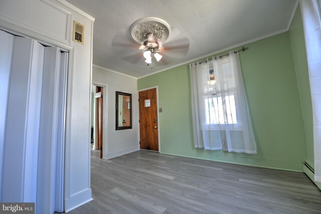 5417 Wasena Ave, Baltimore, MD 21225 - entryway with a ceiling fan, wood finished floors, and crown molding