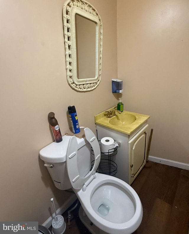 2424 Greenmount Ave, Baltimore, MD 21218 - half bathroom with vanity and wood finished floors