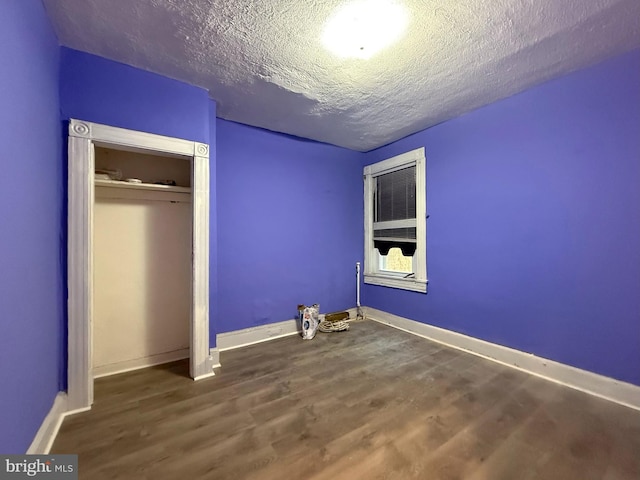2424 Greenmount Ave, Baltimore, MD 21218 - unfurnished bedroom with wood finished floors, a textured ceiling, and a closet