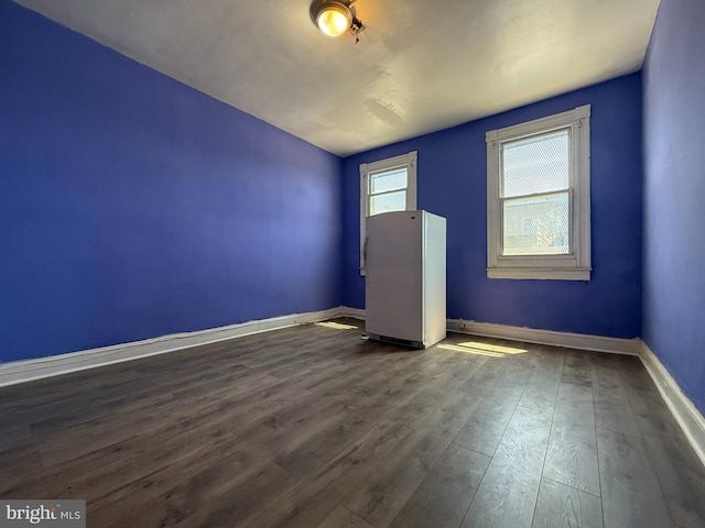 2424 Greenmount Ave, Baltimore, MD 21218 - spare room featuring dark wood-style flooring and baseboards