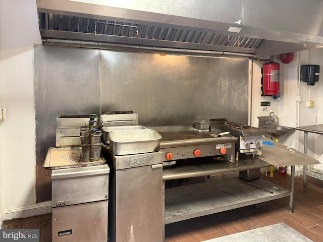 2424 Greenmount Ave, Baltimore, MD 21218 - kitchen with wall chimney range hood and wood finished floors
