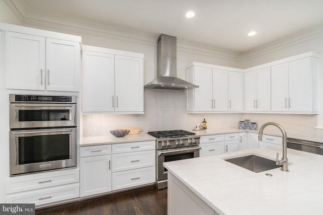 2022 Rockingham St, Mclean, VA 22101 - kitchen with wall chimney exhaust hood, stainless steel appliances, white cabinetry, crown molding, and recessed lighting