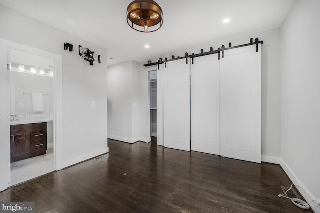 2015 Flagler Pl NW Unit 2, Washington, DC 20001 - unfurnished living room featuring a barn door, wood finished floors, and recessed lighting