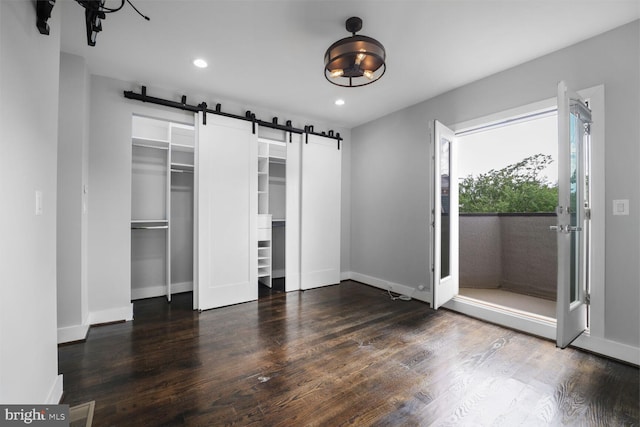 2015 Flagler Pl NW Unit 2, Washington, DC 20001 - unfurnished bedroom with a barn door, multiple closets, wood finished floors, and recessed lighting