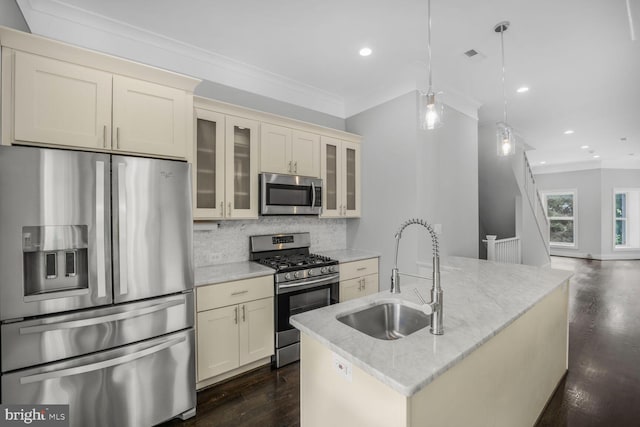 2015 Flagler Pl NW Unit 2, Washington, DC 20001 - kitchen featuring stainless steel appliances, cream cabinets, decorative backsplash, dark wood-style flooring, and crown molding