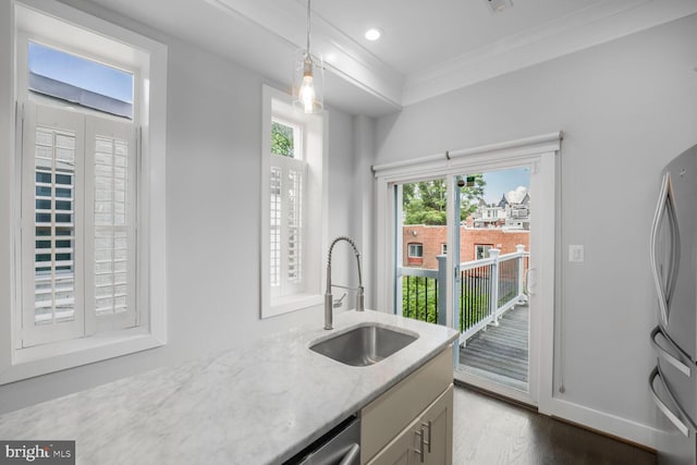 2015 Flagler Pl NW Unit 2, Washington, DC 20001 - kitchen featuring freestanding refrigerator, crown molding, light stone countertops, hanging light fixtures, and dark wood-style floors