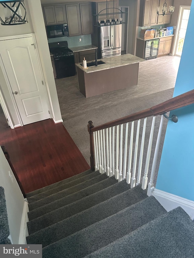 655 Morris Ave, Newfield, NJ 08344 - staircase with carpet flooring and a chandelier