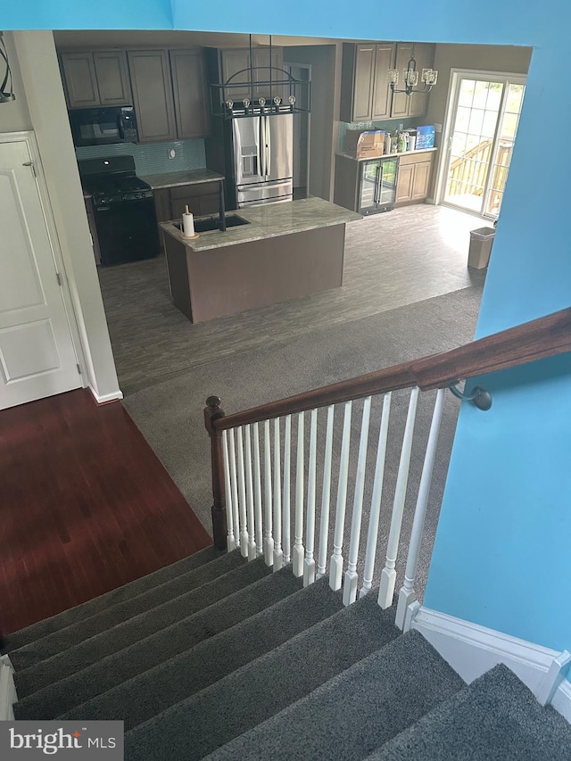 655 Morris Ave, Newfield, NJ 08344 - stairway with carpet floors and a chandelier