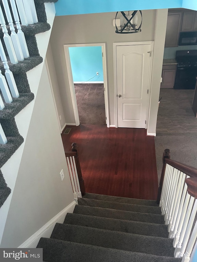 655 Morris Ave, Newfield, NJ 08344 - stairs featuring wood finished floors and carpet floors