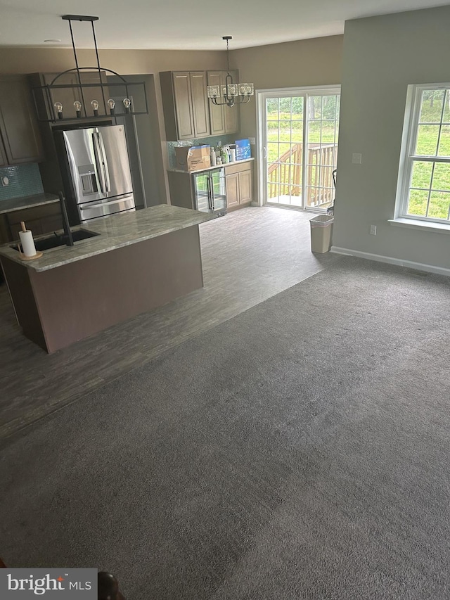 655 Morris Ave, Newfield, NJ 08344 - kitchen featuring a chandelier, stainless steel refrigerator with ice dispenser, a center island, decorative light fixtures, and wood finished floors