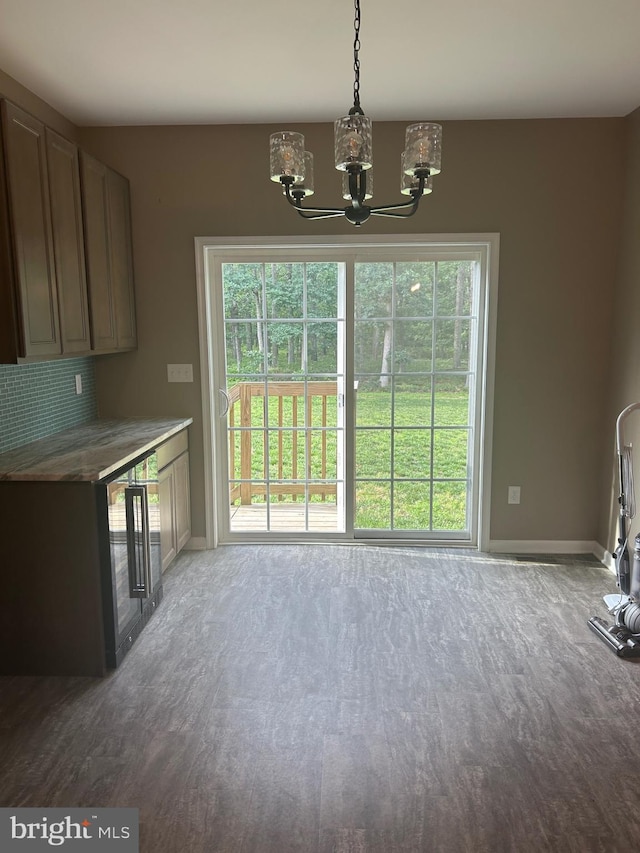 655 Morris Ave, Newfield, NJ 08344 - unfurnished dining area with a chandelier, wood finished floors, and wine cooler