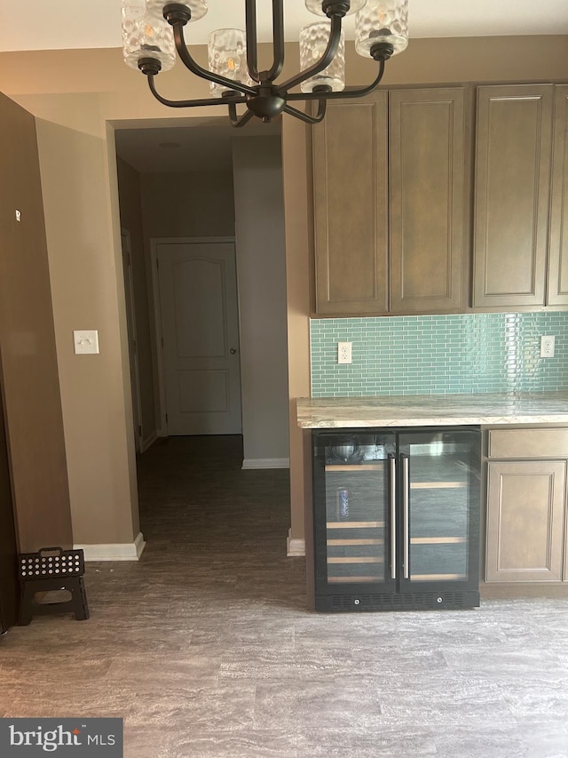 655 Morris Ave, Newfield, NJ 08344 - kitchen with beverage cooler, a chandelier, light countertops, backsplash, and wood finished floors