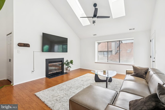 5116 Aberdeen Dr, Mount Laurel, NJ 08054 - living room with a skylight, wood finished floors, a fireplace with flush hearth, and high vaulted ceiling