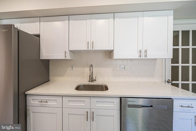 507 Foxwood Ln Unit 507, Paoli, PA 19301 - kitchen with stainless steel appliances, white cabinetry, tasteful backsplash, and light stone counters
