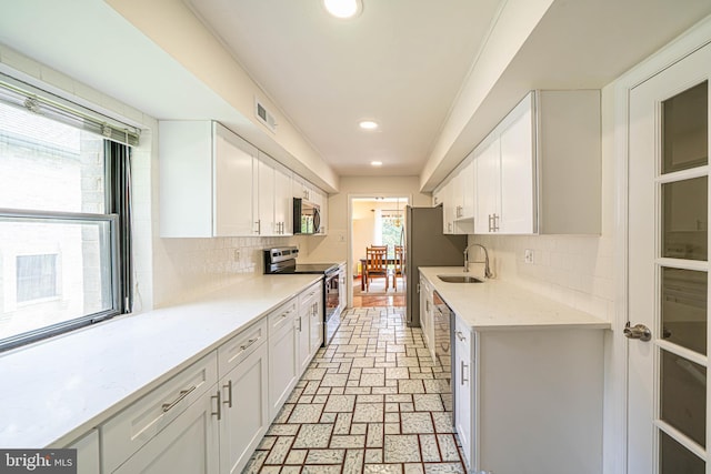 507 Foxwood Ln Unit 507, Paoli, PA 19301 - kitchen featuring appliances with stainless steel finishes, plenty of natural light, white cabinetry, recessed lighting, and tasteful backsplash