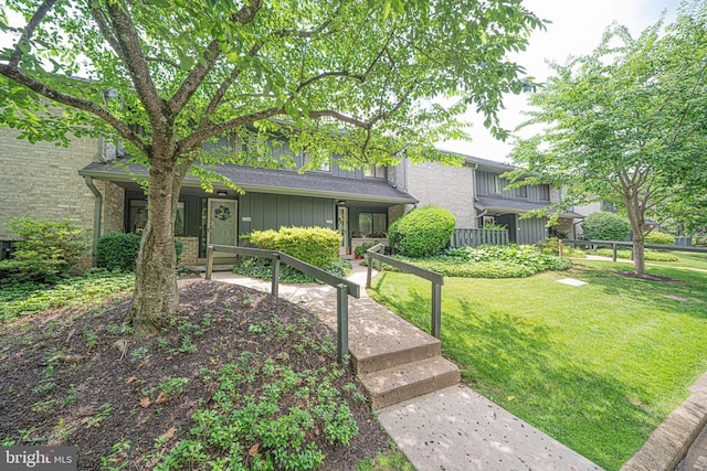 507 Foxwood Ln Unit 507, Paoli, PA 19301 - view of front of home with board and batten siding, a front yard, and brick siding