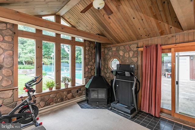 10 Camelia Ct, Lawrence Township, NJ 08648 - exercise area with vaulted ceiling, a wood stove, ceiling fan, wooden ceiling, and dark tile patterned floors