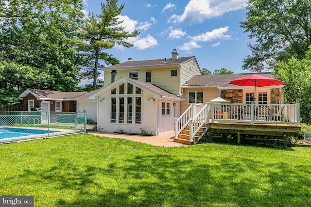 10 Camelia Ct, Lawrence Township, NJ 08648 - rear view of property with a deck, a chimney, board and batten siding, stone siding, and a shingled roof