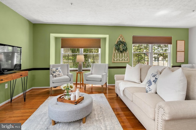 2508 Smoketree Ln, Crofton, MD 21114 - living area with healthy amount of natural light, wood finished floors, and a textured ceiling