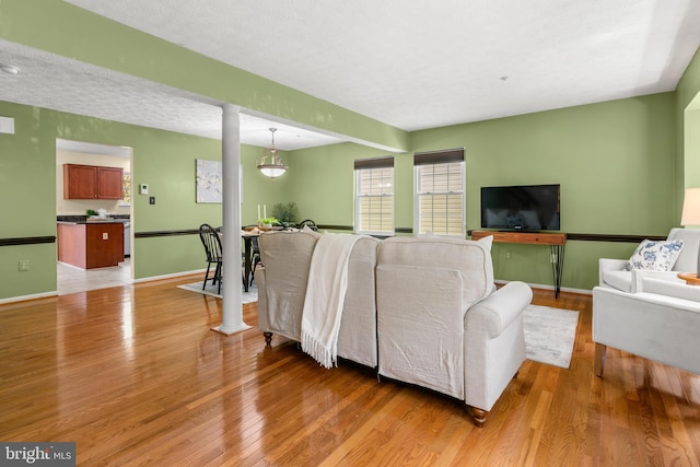 2508 Smoketree Ln, Crofton, MD 21114 - living area featuring light wood-style floors and decorative columns