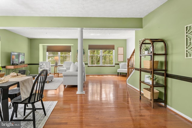 2508 Smoketree Ln, Crofton, MD 21114 - dining space with ornate columns, wood finished floors, a textured ceiling, and stairway