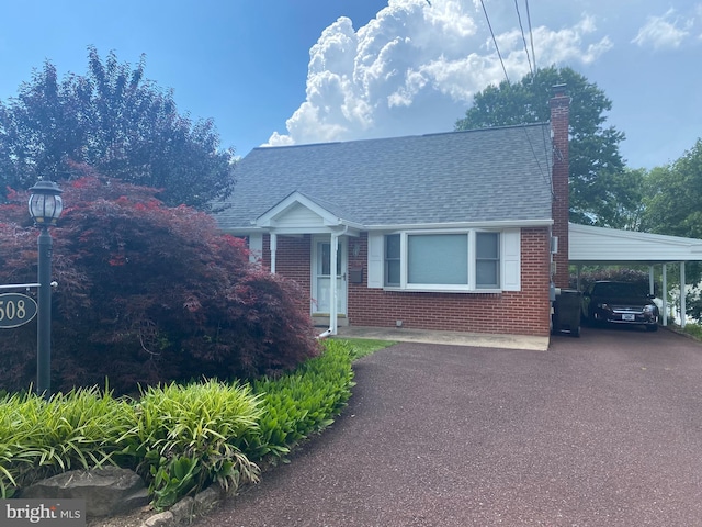 508 Lansdale Ave, Lansdale, PA 19446 - view of front facade with asphalt driveway, a chimney, brick siding, and roof with shingles