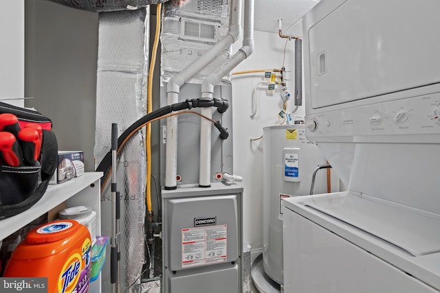 6000 Village Way Unit 308, Upper Chichester, PA 19061 - utilities with stacked washer / dryer and electric water heater