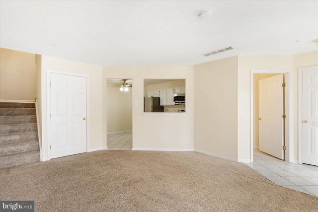4260 Maple Path Cir Unit 15, Nottingham, MD 21236 - unfurnished living room with carpet, stairs, tile patterned floors, and a ceiling fan