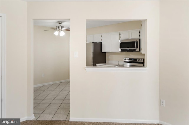 4260 Maple Path Cir Unit 15, Nottingham, MD 21236 - kitchen featuring stainless steel appliances, white cabinets, a ceiling fan, light tile patterned floors, and light countertops