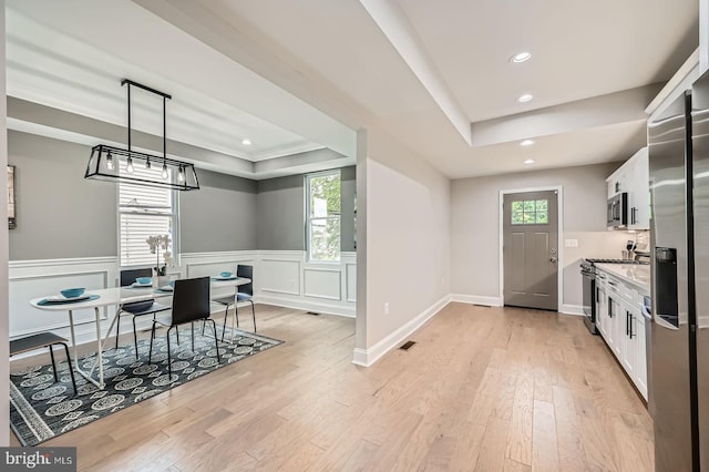 3704 Frankford Ave, Baltimore, MD 21206 - kitchen featuring a tray ceiling, white cabinets, recessed lighting, light wood-type flooring, and appliances with stainless steel finishes