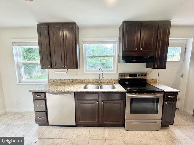 3814 Jancie Rd, Fairfax, VA 22030 - kitchen with stainless steel appliances, under cabinet range hood, dark brown cabinets, and light stone counters