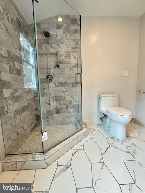 3814 Jancie Rd, Fairfax, VA 22030 - bathroom with a stall shower and marble look tile flooring