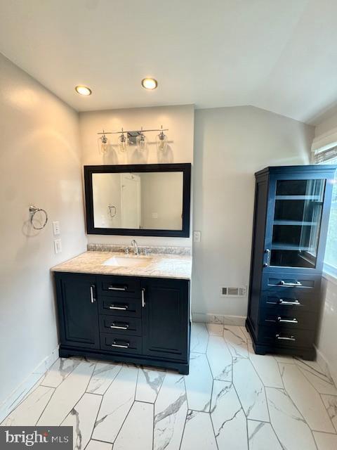 3814 Jancie Rd, Fairfax, VA 22030 - bathroom featuring marble finish floors, vanity, recessed lighting, and vaulted ceiling