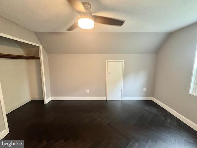 3814 Jancie Rd, Fairfax, VA 22030 - unfurnished bedroom featuring vaulted ceiling, dark wood-style floors, a ceiling fan, and a closet