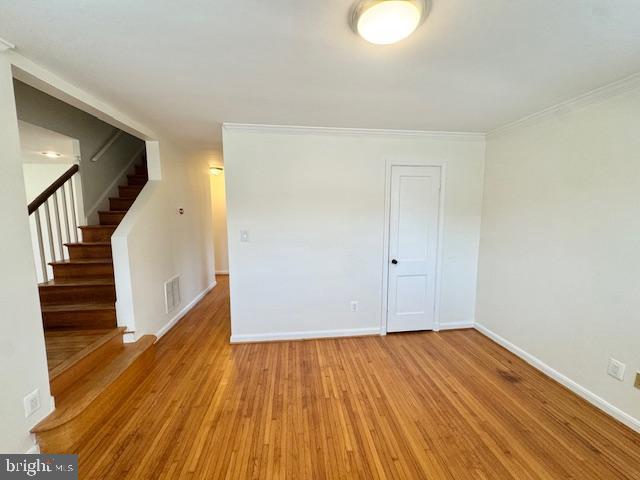 3814 Jancie Rd, Fairfax, VA 22030 - empty room with wood finished floors, stairs, and ornamental molding
