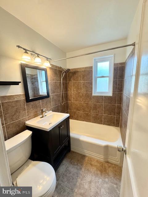 3814 Jancie Rd, Fairfax, VA 22030 - bathroom featuring tile walls, vanity, shower / tub combination, and tile patterned floors