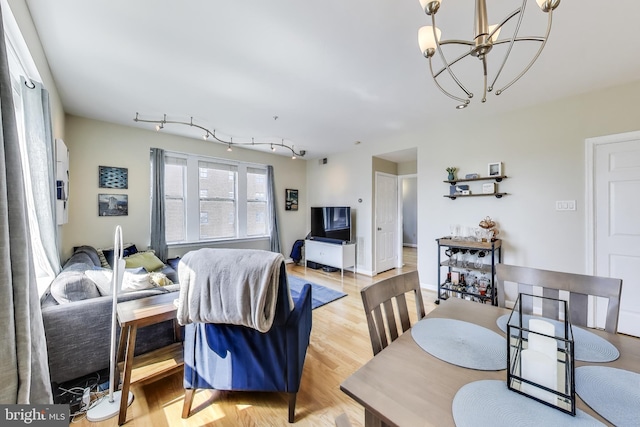 1619 R St NW Unit 501, Washington, DC 20009 - dining room with light wood-style floors and a chandelier