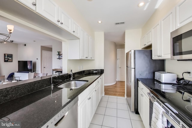 1619 R St NW Unit 501, Washington, DC 20009 - kitchen with appliances with stainless steel finishes, white cabinetry, and recessed lighting