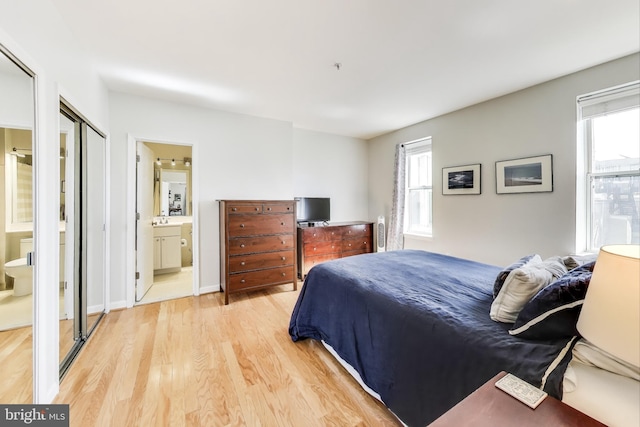 1619 R St NW Unit 501, Washington, DC 20009 - bedroom with light wood finished floors and connected bathroom