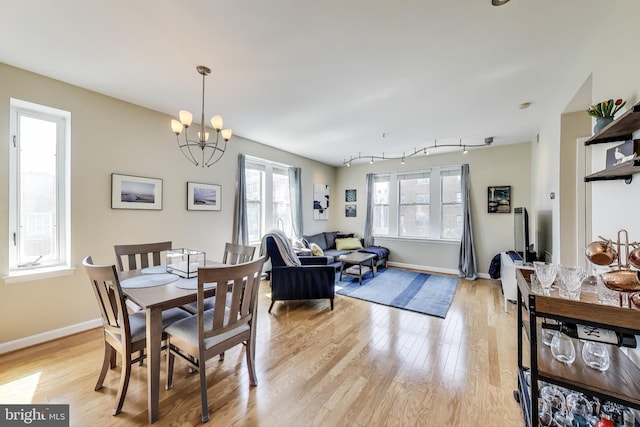 1619 R St NW Unit 501, Washington, DC 20009 - dining room with light wood-style floors and a chandelier