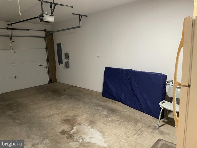 1103 Jousting Way, Mount Airy, MD 21771 - garage featuring electric panel, a garage door opener, and freestanding refrigerator