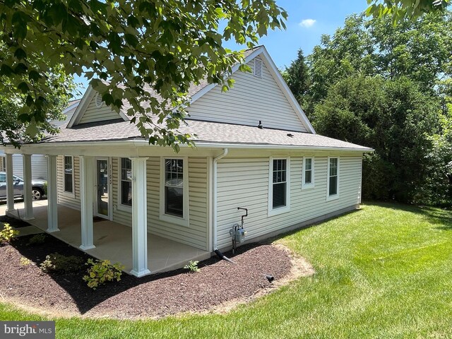 1103 Jousting Way, Mount Airy, MD 21771 - view of side of home with a patio area, a lawn, and a shingled roof