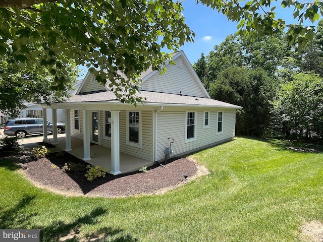 1103 Jousting Way, Mount Airy, MD 21771 - view of side of home featuring a yard, a patio area, and a shingled roof