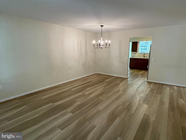 1103 Jousting Way, Mount Airy, MD 21771 - empty room featuring a chandelier and wood finished floors