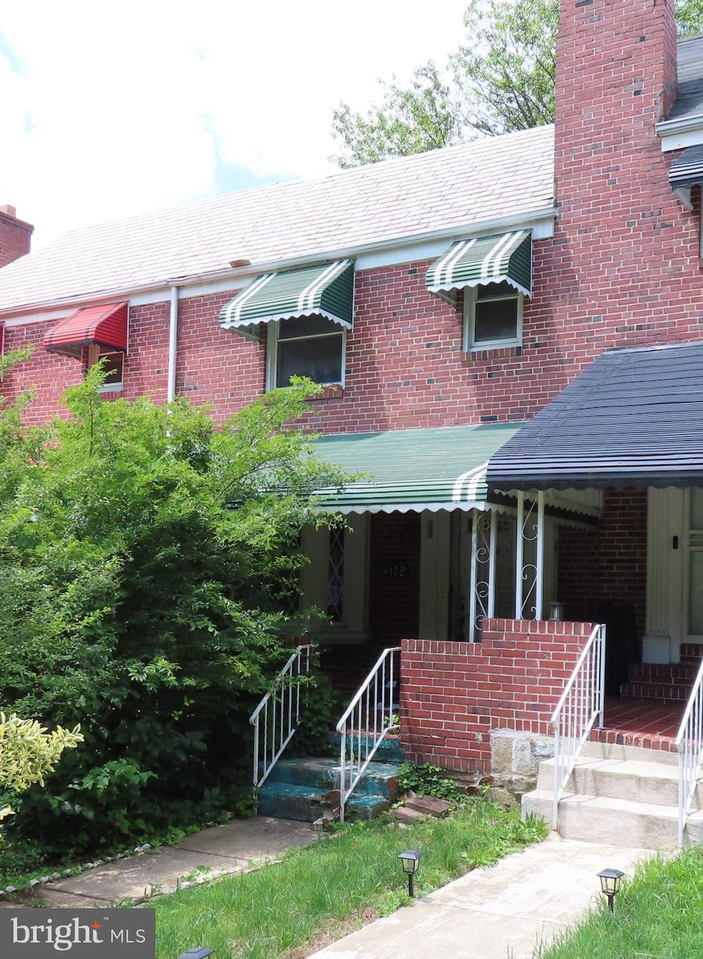 4102 The Alameda, Baltimore, MD 21218 - view of front of home featuring brick siding, a chimney, and covered porch